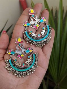 Add charm and charisma to your beautiful personality with these exquisitely handcrafted Afghani earrings made with high quality German Silver. The intricate design and the glass enamel work renders these earrings a very unique and classy look. Pair them up with any formal or casual attire and gather compliments all the way!Weight 25gmLength 2.8"Width 1.8" Multicolor Metal Chandbali Earrings, Traditional Artistic Design Drop Earrings, Festive Multicolor Oxidized Earrings, Elegant Multicolor Earrings With Oxidized Finish, Enamel Earrings For Wedding, Traditional Multicolor Metal Earrings, Traditional Dangle Jewelry With Artistic Design, Multicolor Metal Earrings For Festivals, Unique Silver Danglers For Festive Occasions