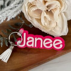 Personalized these name keychains made from Pink Capri backer with White letterings for use on backpacks, luggages, diaper bags, sports bag, gym bags or gift them for bridesmaids. These name tags has multi purpose options and is a perfect back to school gift for girls.Product Details Tags are made with 3MM acrylic backer and stacked with 3MM coloured acrylic Each Tag will be approximately 4" wide and the height will vary based on the nameKeychain hardware included with lobster clasp and coordina Trendy Personalized White Keychains, Personalized Rectangular Keychain For Gift, Rectangular Custom Name Keychains For Personal Use, Personalized Rectangular Keychain Gift, White Rectangular Keychains For Gifts, Trendy White Personalized Keychains, White Rectangular Keychain For Gift, White Rectangular Keychain Gift, Personalized White Keychain For School