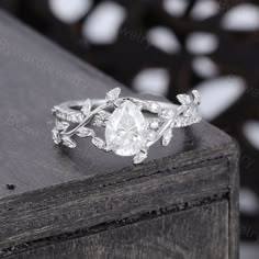 a diamond ring with leaves on it