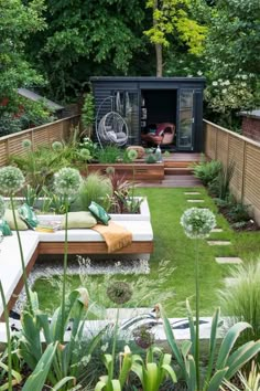 an outdoor garden with lots of green grass and plants in the area, including a bench