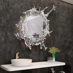 a bathroom with a sink and mirror on the wall above it is decorated in black and white