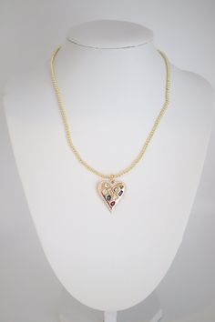 A Gold Beaded Necklace with Heart Pendant combines timeless elegance with a touch of romance, featuring a string of gold beads leading to a heart-shaped pendant. This accessory adds a sweet and sophisticated element to any outfit, making it a versatile and sentimental piece of jewelry. Elegant Gold Beaded Necklaces For Valentine's Day, Elegant Heart-shaped Jewelry With Gold Beads, Gold Plated Heart Beaded Necklace For Anniversary, Gold Plated Heart Beads Necklace For Valentine's Day, Heart-shaped Beaded Wedding Necklaces, Gold Plated Heart Beads Necklace For Anniversary, Gold Plated Heart Necklace For Party, Elegant Beaded Heart Necklace, Elegant Gold Beaded Necklace With Heart Beads