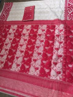 Traditional Handwoven Dhakai Jamdani Saree in White with Red border Pallu. Very soft reshom by cotton fabric ,smooth texture. Traditional korat motifs mostly used in Dhakai Jamdani Sarees. With blouse piece. Saree 5.5 mtr apx. Blouse piece 1 mtr apx. as they are handwoven items so is the approximate measuments. Dry wash only. Due to digital photography little variation in color may occur. In Handwoven sarees thread pulls or thread missing are very common as these are hand made not machine made or power loom.These imperfections are the sign of authenticity and genuineness. So this will not be considered as damage, though such defects are negligible and we take care of this very much. Kolkata Saree, Dhakai Jamdani Saree, Korat, Jamdani Saree, Red Border, Durga Puja, Saree Online, Power Loom, Kolkata