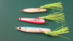 three different types of fishing lures on a green surface