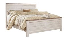 a white bed with wooden headboard and foot board