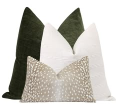 two green and white pillows sitting next to each other