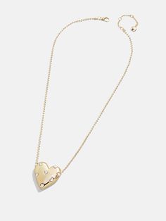 Every jewelry box needs a heart silhouette, and the Melina Necklace just might be our favorite choice. A chunky gold heart pendant is strung on a classic gold chain and adorned with tiny, pretty glass stones. We love this one layered with a few other dainty chain styles to really round out your stack. Heart Silhouette, Gold Heart Pendant, Heart Pendant Gold, Gold Gifts, Dainty Chain, Classic Gold, Gold Heart, Heart Of Gold, Heart Pendant Necklace