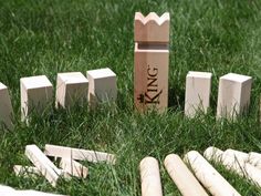 a wooden block set sitting in the grass