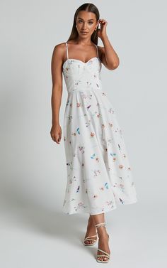 Make a statement in our Robertson Midi Dress - Strappy Sweetheart Bustier Flare Dress In Painterly Wild Flower! This stunning white dress is perfect for any party or day event. The sweetheart neckline adds a touch of femininity, while the midi length and fit & flare silhouette create a flattering shape. Made from poplin polyester, this dress is not only comfortable but also easy to care for. Whether you're heading to a wedding or brunch with friends, our Robertson Midi Dress will have you lo White Midi Dress With Spaghetti Straps And Fitted Bodice, Feminine Lined Midi Dress With Sweetheart Neckline, White Midi Dress With Fitted Bodice For Casual Wear, Summer Dress Down Dress With Sweetheart Neckline, Feminine White Midi Dress With Lined Bodice, Summer Dress With Sweetheart Neckline For Casual Wear, Summer Dress With Sweetheart Neckline For Casual Occasions, Summer Dresses With Sweetheart Neckline For Daywear, White Fitted Summer Dress