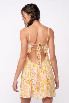 The Drew Peach Floral Babydoll Cami Mini Dress is here for sunshine and fun summer days! White, peach, and yellow floral fabric forms this cute floral bralette babydoll dress with cami straps and a bralette cutout bodice. The attached mini skirt falls from an empire waist. A ruffle back with ties finishes the look! Style with cute sandals for a fun summer look! DETAILS & CARE 100%Rayon. 100% Polyester Lining. Machine wash cold. Imported. White Cutout Mini Dress, Spring Dresses With Built-in Bra For Brunch, Spring Sundress With Spaghetti Straps And Built-in Bra, Summer Sundress With Built-in Bra For Vacation, Summer Sundress With Delicate Straps, Mini Length, Summer Sundress With Delicate Straps And Mini Length, Summer Sundress With Delicate Straps In Mini Length, Spring Cotton Sundress With Straps, Pink Dresses With Crisscross Straps For Brunch