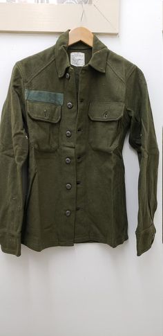 Vintage Military Issued Vietnam Era Wool ShirtSize-Extra SmallChest-up to 33 inches85% Wool 15% NylonDated-1976Condition-USED but looks NEW-see picsNSN# 8405-00-188-3794Made in the USA! check us out at www.armysurpluswarehouselexington.com Olive Military Style Tops For Fall, Military Style Green Tops For Fall, Fall Military Green Tops, Green Military Style Tops For Fall, Military Style Green Winter Tops, Winter Military Collared Tops, Military Style Workwear Tops With Snap Buttons, Military Style Collared Top With Snap Buttons, Fitted Military Collared Top