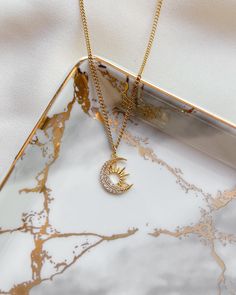 ✧ Stainless Steel ✧ Pendant: 14K Gold Plated Step into a world where the sun and moon dance in perfect harmony with this exquisite Sun & Moon Necklace. Handmade in the South of France, this piece captures the eternal beauty of the cosmos with a timeless design that blends delicate craftsmanship with celestial symbolism. The 14k gold plating adds a warm, luminous glow to the intricate sun and moon pendants, evoking a sense of mystery and wonder. The sun radiates vitality and strength, while the m Necklace Sun And Moon, Sun Moon Necklace, Sun And Moon Pendant, Gold Sun Necklace, Moon Necklace Gold, Sun And Moon Necklace, Necklace Sun, Star And Moon Necklace, Colors Aesthetic