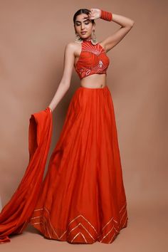 Tangerine orange kali lehenga with synodic chevron wave gota lace embellishments on the border, invisible belt and side pockets detailing. Paired with a halter neckline blouse with bloom ray embroidery using cutdana, resham, moti, zardozi highlights and a lace border dupatta. - Aza Fashions Orange Silk Choli With Cutdana, Festive Semi-stitched Orange Lehenga, Orange Silk Semi-stitched Lehenga, Unstitched Orange Silk Lehenga, Unstitched Orange Lehenga With Cutdana, Kali Lehenga, Lace Embellishments, Lehenga Pattern, Tangerine Orange