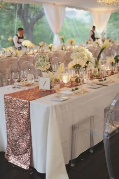 the table is set with white and gold decorations