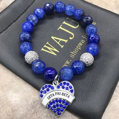 a blue beaded bracelet with an open heart charm and the words utah on it