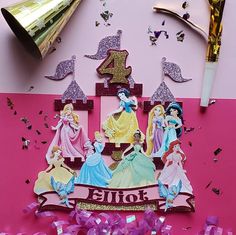 a pink birthday card with princesses on it and confetti streamers in the background