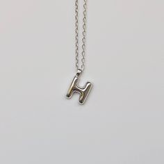 "Sterling silver initial necklace. Each letter is carved in wax and then cast in solid sterling silver.  Once the alphabet is cast in metal it is cleaned up and turned into a pendant before being put on a chain.  Comes in a shiny finish but can be done in a satin finish upon request.  Dimensions:  Initial - 10mm/1cm  Chain - 16\" (for a different length please get in touch)  Choose your alphabet of choice from the drop down menu including whether you want the pendant with or without chain.  All our jewellery is made to order so please allow upto 2 weeks for your initial to be prepared especially for you." Letter Pendant Necklace Silver, Silver Bubble Letter Necklace, Silver Letter Necklace, Bubble Alphabet, Delicate Diamond Necklace, Letter Necklace Initials, Sterling Silver Initial Necklace, Letter Necklace Silver, Silver Initial Necklace