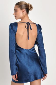 Everyone will want your attention when you're looking so good in the Lulus Adoring Charm Dark Blue Satin Long Sleeve Backless Mini Dress! Sleek woven satin, with a subtle brushed effect throughout, shapes long sleeves with split cuffs and striking gathered shoulders. Bodice has a cowl neckline and a stunning open back, crossed by a single tie. Figure-skimming silhouette continues down to a flaring skirt, finishing at a mini hem. Hidden zipper at side. Fit: This garment fits true to size. Length: Blue Fitted Low Back Dress, Blue Fitted Dress With Low Back, Blue Backless Dresses With Built-in Bra, Fitted Backless Mini Dress With Built-in Bra, Fitted Blue Mini Dress With Tie Back, Blue Fitted Mini Dress With Tie Back, Fitted V-neck Backless Dress With Ruched Back, Fitted Blue Backless Dress For Night Out, Blue Backless Dress With Back Opening