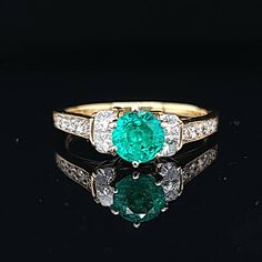 Gorgeous 18k Yellow gold ring natural green Emerald, Center round shape weight 0.92ct. size 5.9m very nice rich medium green color nice luster lively,brilliant stone and clean. side diamonds total weight 0.50ct. SI1-G ring size 7.5 Resizable Retail value $6,500 net . Appraisal available Vintage Platinum Rings, 18k Yellow Gold Ring, Platinum Ring, Natural Aquamarine, Green Emerald, Yellow Gold Ring, Gold Engagement, Ring Size 7, Yellow Gold Rings