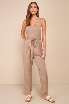 The secret to effortless dressing is having elevated pieces like the Lulus Poised Simplicity Light Brown Backless Overall Slim Leg Jumpsuit to rely on! Lightweight, slightly textured linen-like woven fabric shapes this chic jumpsuit that has wide buttoning adjustable tank straps and an apron-style bodice with an open back. Removable sash belt wraps the waist, atop slim legs with front diagonal pockets that ends at ankle-length hems. Hidden zipper/clasp at back. Fit: This garment fits true to siz Jumpsuits For Women Casual, Brown Jumpsuits, Chic Jumpsuit, Casual Formal Dresses, Jumpsuit Chic, Lulu Fashion, Backless Jumpsuit, Casual Wedding Dress, Sash Belt