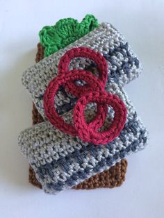 three crocheted items are stacked on top of each other