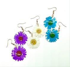 Handmade earrings made with love and care! They are an excellent addition to any wardrobe for a simple yet elegant look. 🌸 One pair of resin earrings with a delicate pressed daisy 🌸 Materials: Pressed daisy flower & Resin Your jewelry is handcrafted, making each perfectly unique and beautiful just like you!   For each purchase, $2 will go towards funding my organization: MAUA Women's Foundation that aims to provide sustainable feminine hygiene products to girls in rural Kenya, Africa. Facebook page: https://www.facebook.co/MAUAWomensFoundation Care: Remove your jewelry when in contact with water or liquids such as perfume or lotion. Store your beautiful resin jewelry in a cool dark place and out of direct sunlight to maintain the vibrant colors. Feminine Hygiene Products, Real Flower Earrings, Pressed Flower Earrings, Hygiene Products, Flower Resin, Feminine Hygiene, Daisy Earrings, Earrings Christmas, Resin Earrings