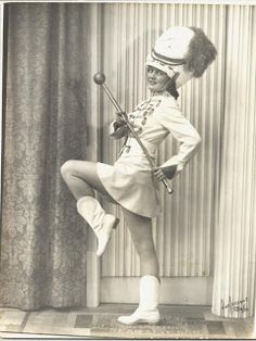 an old black and white photo of a woman in uniform