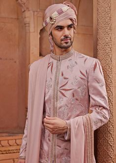 Step into the spotlight with the stunning Nude Pink Embroidered Sherwani Set, a creation that embodies grace and grandeur. Made from luxurious silk jacquard, the pink sherwani is adorned with intricate tonal velvet applique work and floral butta motifs, highlighted with zari and dabka embroidery, adding a touch of opulence. Paired with a matching kurta and pants, designed for a comfortable yet stylish fit, and completed with an embroidered stole, this ensemble ensures both a rich texture and a refined appearance. Ideal for the groom on his special day, this outfit combines traditional craftsmanship with contemporary design, offering a timeless appeal that exudes elegance. Composition : Sherwani, Stole, Kurta and Churidar - Silk JacquardCare: Dry Clean Only and Vacuum Storage Delivery : 4-6 Manpreet Toor, Pink Sherwani, Dabka Embroidery, Velvet Applique, Kaftan Kurta, Kurta And Pants, Kurta Pants, Kurta Lehenga, Embroidered Sherwani