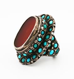 Central Asian Bukharan Uzbek and Turkmen Silver Ring with Turquoise and Carnelian Stones The Türkmen (Türkmen: Türkmen, Түркмен, توركمن) are an Oğuz Turkic speaking ethnic group that inhabit Türkmenistan (Turkmenistan) but also have sizeable populations in Afğanistan (Afghanistan), Türkiye (Turkey), and other Central-Asian countries. They are famous for their masterfully made jewelry. Their jewelry is typically made of high-quality silver and carnelian stones. Openwork designs, granulation, and gilding are common traits of their work. Whereas the Özbek (Özbek: Oʻzbek; Ўзбек, اوزبک) are a Qarluq Turkic speaking ethnic group, who primarily reside in Özbekistan (Uzbekistan). They also have sizeable populations in other Central Asian countries such as Afğanistan and Qırğızstan (Kyrgyzstan), am Traditional Turquoise Inlay Ring, Traditional Oval Turquoise Ring, Traditional Turquoise Gemstone Ring, Traditional Silver Turquoise Ring, Afghanistan Jewelry, Turkoman Jewelry, Ethno Style, Asian Countries, Carnelian Stone