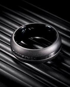 a black ring sitting on top of a table