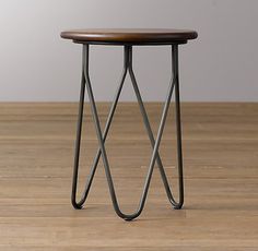 a small wooden table sitting on top of a hard wood floor