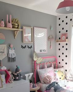 a child's bedroom with pink and gray decor