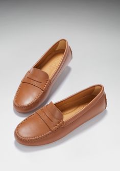 Hugs & Co. tan leather penny loafer driving shoes for women. Moccasin style driving loafers in luxurious tan outer and lined with a soft leather for extra comfort. Made in Portugal 100% leather upper featuring a 100% leather Lining rubber studded sole Classic Cognac Slip-on Moccasins, Brown Slip-on Driving Loafers, Elegant Brown Driving Moccasins, Elegant Brown Driving Loafers, Driving Loafers With Rubber Sole, Classic Leather Footbed Driving Loafers, Classic Driving Loafers With Leather Footbed, Classic Leather Moccasins In Cognac, Classic Leather Moccasins In Cognac Color