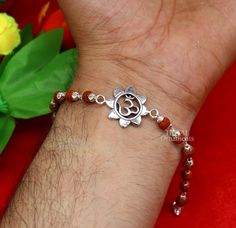 This amazing silver Rakhi crafted from 925 silver with immense precision. It exudes excellent craftsmanship and will surely look wonderful on your brother's wrist. handmade custom design Aum or OM Bracelet Or Rakhi bracelet this is special design beaded bracelet we can use either Rakhi bracelet or daily use bracelet for unisex. Best Rakshabandhan wishes sibling gift for your brother and sister's , buyer can be select bracelet style from option we have Rudraksh, black basil rosary, white rosary a Rudraksh Rakhi Design, Symbolic Sterling Silver Bracelets For Festivals, Handmade Sterling Silver Bracelet For Festivals, Silver Beaded Bracelets With Round Beads For Festivals, Spiritual Sterling Silver Bracelet For Festivals, Fusion Style Sterling Silver Beaded Bracelets As Gift, Sterling Silver Fusion Beaded Bracelets As Gift, Sterling Silver Fusion Beaded Bracelets For Gifts, Handmade Spiritual Sterling Silver Bracelet