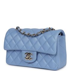 This mini rectangular flap bag is of light blue lambskin leather with light gold tone hardware and has a front flap with signature CC turnlock closure, rear half moon pocket, single interwoven light blue leather and light gold tone chain link shoulder/crossbody strap.The interior is lined in light blue leather and features a zipper pocket with Chanel pull and an open pocket below.Collection: 30-series (2019-2020)Origin: FranceCondition: Never wornAccompanied by: Chanel box, Chanel dustbag, carebook, COA card and feltMeasurements: 7.5" width x 5" height x 2.5" depth; 22.5" strap drop Light Blue Purse, Handbags Aesthetic, Chanel Mini Rectangular, Chanel Handbags Classic, Blue Chanel, Chanel Mini Flap Bag, Small Drawstring Bag, Chanel Clutch, Blue Handbag