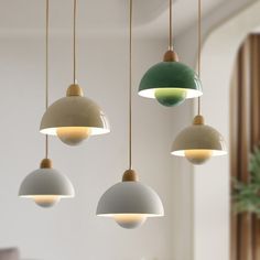 three different colored lights hanging from a ceiling