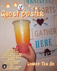 a person holding up a drink in front of a sign that reads ghost busters gather here