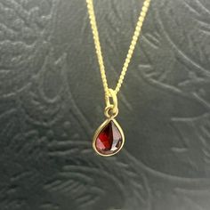 A red Garnet drop pendant with a brass necklace sounds like a beautiful piece of jewelry. Garnet is a deep red gemstone known for its rich color and symbolism of love and passion. The brass necklace adds a touch of elegance and complements the red Garnet pendant nicely. It would make a great addition to any jewelry collection or a thoughtful gift for someone special. Red Ruby Gemstone Necklaces, Red Ruby Drop Jewelry, Red Ruby Gemstone Necklace, Red Drop Beads For Jewelry Making, Red Ruby Birthstone Necklaces, Red Gemstone Drop Jewelry, Red Gemstone Pendant Necklaces, Red Drop Gemstone Jewelry, Red Gemstone Pendant Necklace