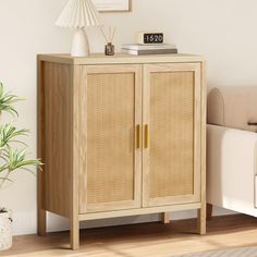 a wooden cabinet sitting on top of a hard wood floor next to a white couch