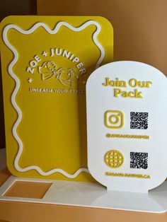 a yellow and white card with some stickers on it next to another one that says join our pack