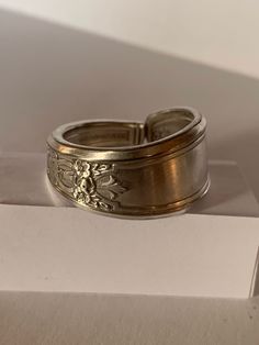 "Handcrafted from a vintage 1847 Rogers Bros silver plated spoon, this ring earns the \"Ambassador\" label through its intricate interwoven symbols representing many nations. Pictured here is a size 11. For other sizings, please ask! We'll try to find you a fit." Adjustable Engraved Antique Silver Ring, Antique Silver Engraved Ring, Antique Silver Engraved Open Ring, Handmade Antique Silver Engraved Ring, Antique Silver Toe Ring, Vintage Handmade Wide Band Jewelry, Handmade Vintage Wide Band Jewelry, Vintage Adjustable Toe Ring, Unique Stamped Antique Silver Rings