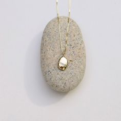 Wishing Stone Necklace, Gold Pebble Necklace, Diamond Pebble Pendant, Gold Diamond Charm, Solid Gold Pebble Necklace They say a pebble with a continuous white line around it is a wishing stone that can grant your deepest desire. This is not that stone. This gold and diamond pebble stands for something more empowering: You can grant your deepest desire. No matter how impossibly big your dream may seem, at its heart is something entirely within reach: the freedom of becoming who you most want to b Morse Code Necklace, Wishing Stones, Pebble Pendant, Pebble Necklace, Necklace Diamond, Diamond Charm, Deep Breath, Pendant Gold, Moon Necklace