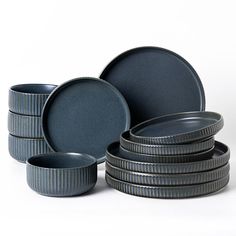 a stack of plates and bowls on a white background