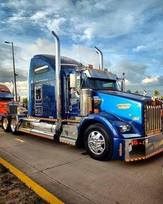 a large blue semi truck parked in a parking lot