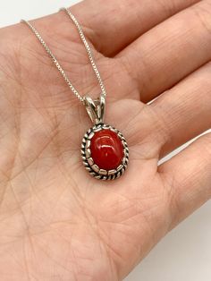 Red Coral Necklace set with a Natural Red Coral in a top grade & strong red color, at 10x8mm, 3 Cts, from Sardinia. Solid 925 Sterling Silver ☞ made to last.Matching Ring & Matching Earrings: Please ask meDetails: • Natural Red Coral sourced from Sardinia• Red Coral: 10x8mm, 3 Cts, diamond cut• Dimensions: Pendant Height 19.6mm, Width 9.2mm• Free Complimentary Chain• Solid 925 Sterling Silver ❀ Each Natural Gem is unique & will have Slight variations from the product pictures "no two Natural Sto Classic Red Jewelry As A Gift, Classic Red Gemstone Jewelry, Classic Red Pendant Necklace, Handmade Red Oval Necklace, Classic Red Round Jewelry, Elegant Red Jewelry With Cabochon, Elegant Red Cabochon Jewelry, Classic Red Necklaces For Anniversary, Classic Red Hallmarked Necklace