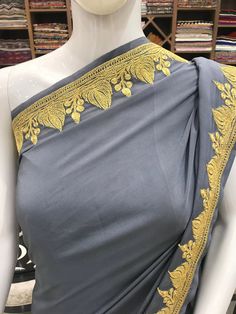 A Marvellous Embroidered Kashmiri Saree which you can wear at any party or wedding. - - - - - - - - - - - - - - - - - - - -  Product Details - Condition: Brand New - Dress Style: Kashmiri Saree - Embroidery: Zari/Tilla Hand Embroidery - Colour: Grey - Embroidery Colour: Gold F A B R I C Saree: Pure Crepe Blouse: Pure Crepe F I N I S H - Unstitched You can get it stitched locally. - Stitched Want your blouse ready to wear, let us know the style you want and we will stitch it for you. PLEASE NOTE: Kashmiri Hand Embroidery, Hand Embroidery Saree, Kashmiri Saree, Kashmir Embroidery, Bohemian Jackets, Saree Women, Summer Coats, Crepe Blouse, Traditional Outfit