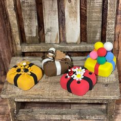 small wooden toys sitting on top of a wooden chair next to each other in different colors