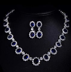 Channel timeless elegance with this Princess Diana-inspired Sapphire Necklace and Ring Set, part of our exquisite India Diamond Jewelry collection. The deep blue allure of the sapphire necklace perfectly complements the brilliance of American Diamonds in this bridal wedding set. Embrace sophistication and regal charm with this captivating ensemble. *𝐏𝐑𝐎𝐃𝐔𝐂𝐓 𝐃𝐄𝐓𝐀𝐈𝐋* * Material: Brass * Plating: White Rhodium Plated * Stone: AAA Quality CZ Diamond & Sapphire. *𝐃𝐈𝐌𝐄𝐍𝐒𝐈𝐎𝐍𝐒* *    Necklace- Weight: 32 gm, Length: 8.7 Inches, Drop Length: 4.5 Inches, Width: 0.7 Inches *    Earrings- Weight: 6 gm Each, Length: 1.65 Inches, Width: 0.65 Inches *𝐒𝐇𝐈𝐏𝐏𝐈𝐍𝐆 𝐏𝐎𝐋𝐈𝐂𝐘* * Shipping: worldwide from India. * Free shipping: All our products have a free standard shipping polic Sapphire Jewelry With Sparkling Stones For Wedding, Blue Teardrop Jewelry With Diamond Accents, Elegant Pear-shaped Blue Jewelry, Elegant Blue Teardrop Necklace, Blue Teardrop-shaped Jewelry With Diamond Accents, Elegant Blue Pear-shaped Jewelry, Party Sapphire Cubic Zirconia Necklace, Sapphire Cubic Zirconia Necklace For Party, Sapphire Cubic Zirconia Necklaces For Party