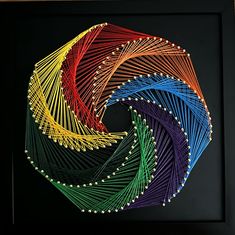 an art work with many different colors and lines in the shape of a spiral on a black background