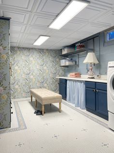 a washer and dryer in a room with blue cabinets